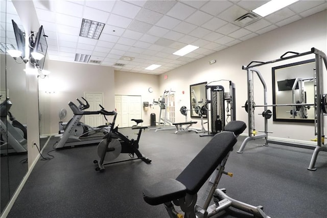 exercise room with a paneled ceiling