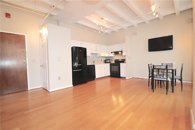 kitchen with white cabinetry, light wood-type flooring, tasteful backsplash, and black appliances