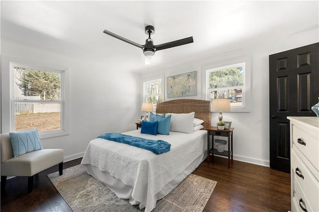 bedroom with ceiling fan and dark hardwood / wood-style flooring