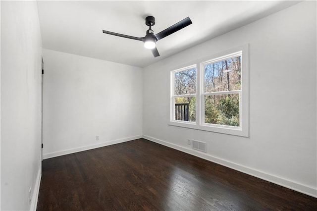 spare room featuring dark hardwood / wood-style flooring and ceiling fan