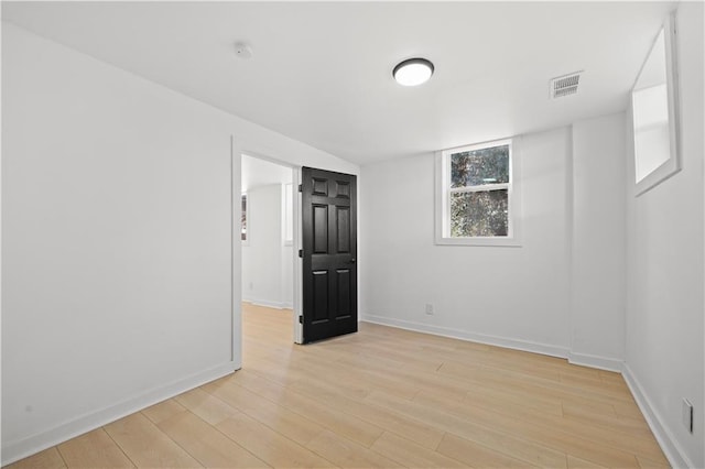 spare room featuring light hardwood / wood-style flooring