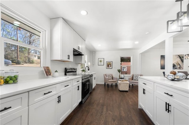 kitchen featuring white cabinetry, stainless steel electric range, pendant lighting, and dark hardwood / wood-style floors