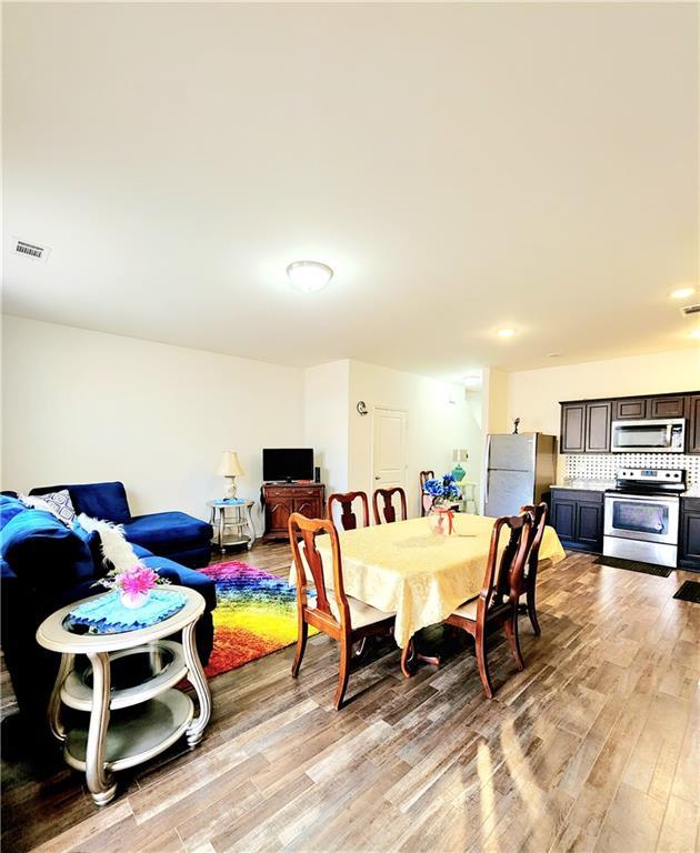 dining room featuring visible vents and light wood-style floors