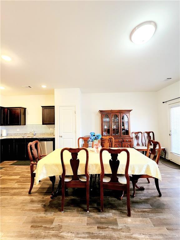 dining room with recessed lighting and light wood-style floors