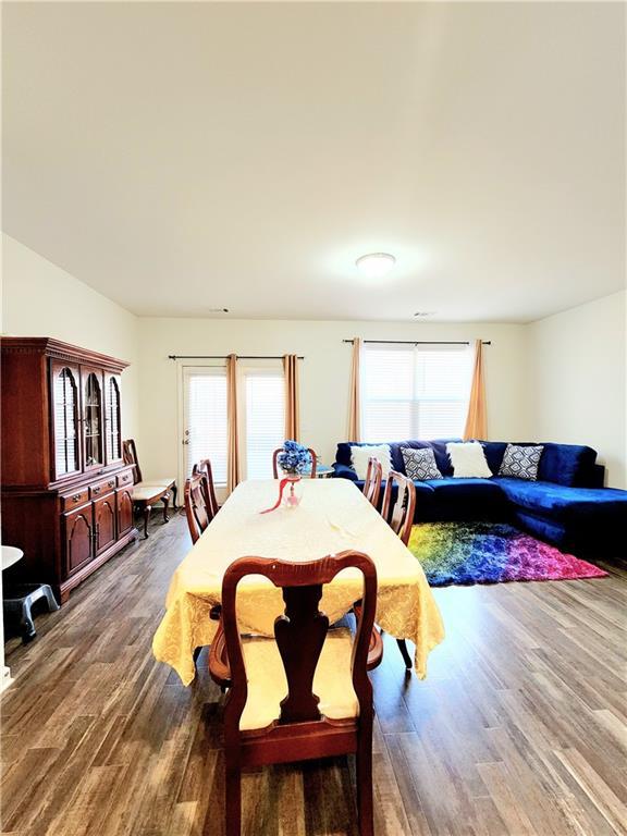 dining room with plenty of natural light and wood finished floors