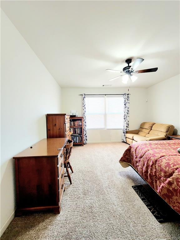 bedroom with carpet flooring, a ceiling fan, and baseboards