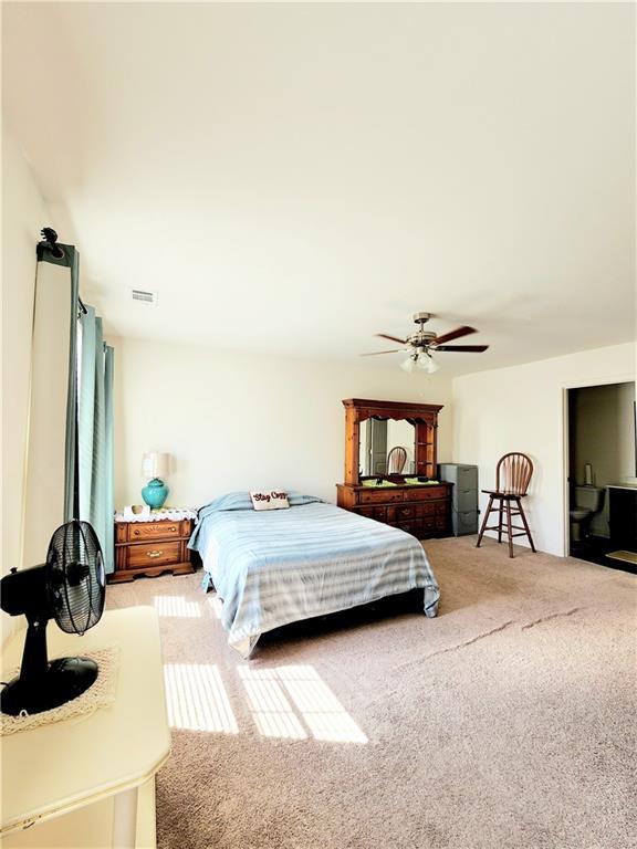 bedroom featuring visible vents, carpet floors, and ceiling fan