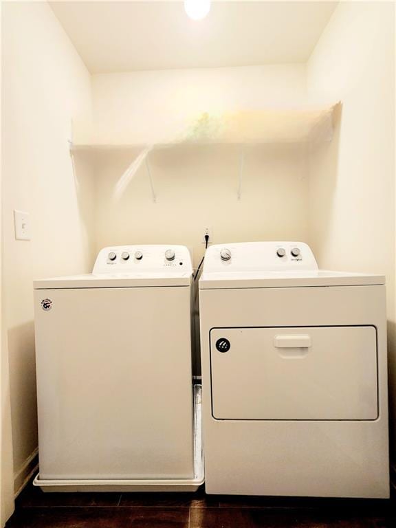 laundry area with dark wood-style floors, laundry area, and separate washer and dryer