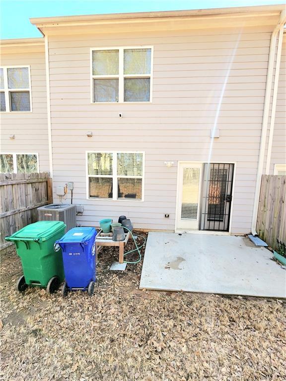 back of house featuring central AC unit, a patio, and fence