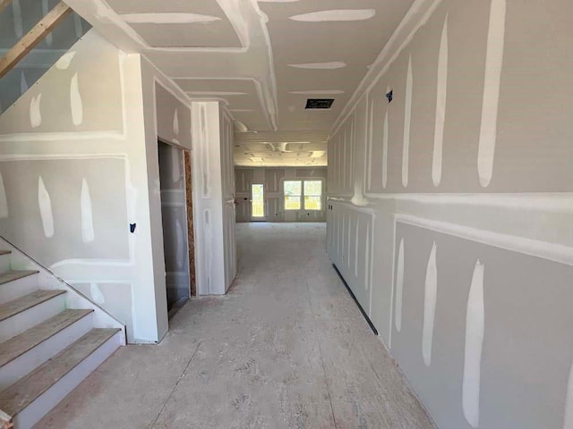 corridor featuring stairway and visible vents