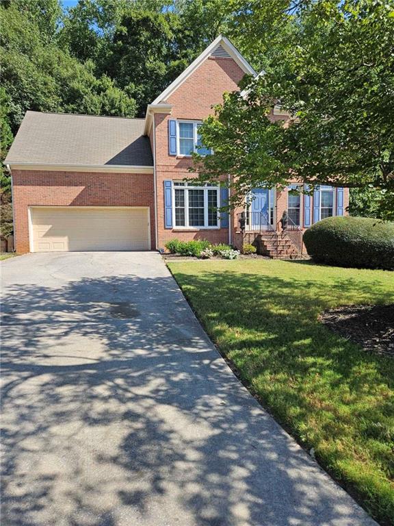 view of front of house with a front yard and a garage