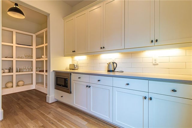 2067 Telfair Cir Unit A & B, Atlanta, GA 30324 - kitchen with stainless steel microwave, decorative backsplash, light wood finished floors, and light countertops