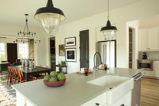 2067 Telfair Cir Unit A & B, Atlanta, GA 30324 - kitchen featuring stainless steel appliances, a chandelier, white cabinetry, decorative light fixtures, and light countertops
