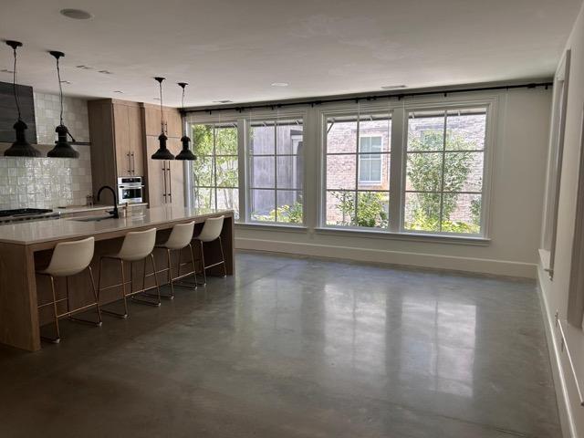 2067 Telfair Cir Unit A & B, Atlanta, GA 30324 - kitchen with oven, a sink, baseboards, finished concrete floors, and tasteful backsplash