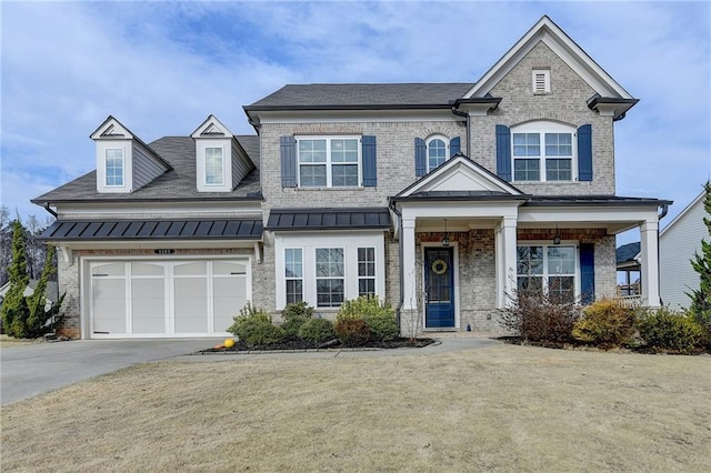 view of front of home with driveway, metal roof, an attached garage, a standing seam roof, and brick siding