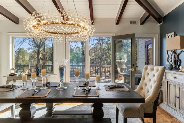 interior space featuring beam ceiling, light hardwood / wood-style flooring, and a chandelier