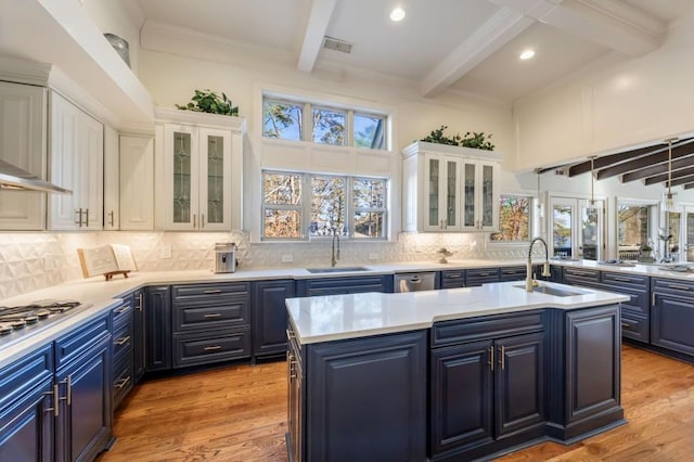 kitchen with white cabinetry, beam ceiling, and blue cabinetry