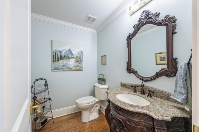 bathroom with ornamental molding, wood-type flooring, vanity, and toilet