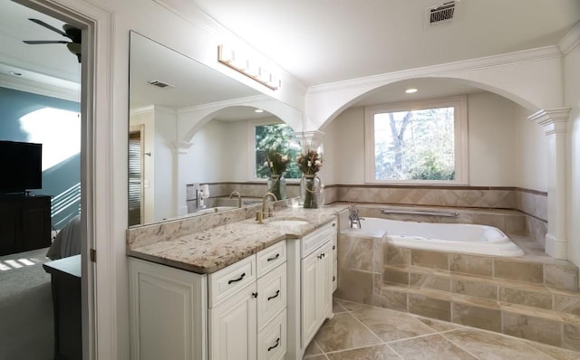 bathroom with tile patterned floors, crown molding, vanity, a relaxing tiled tub, and ceiling fan