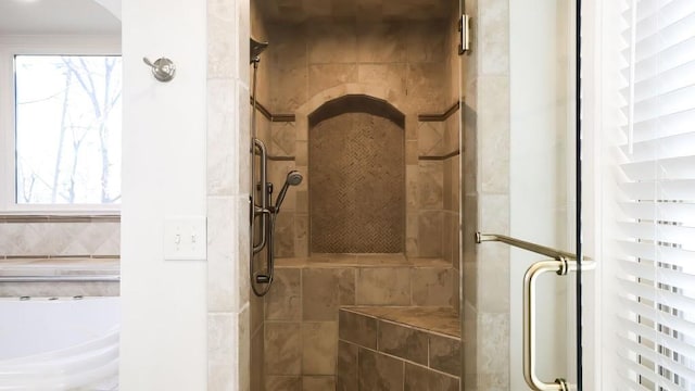 bathroom featuring a shower with shower door