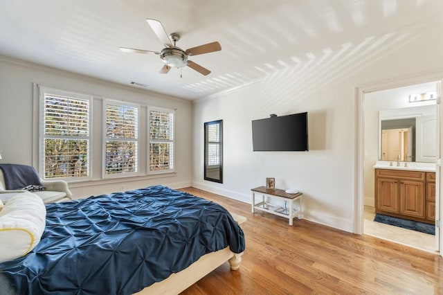 bedroom with sink, ceiling fan, crown molding, ensuite bath, and light hardwood / wood-style flooring