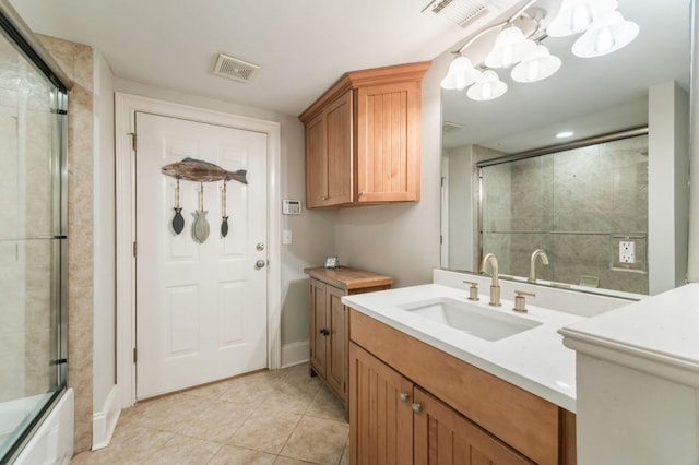 bathroom featuring bath / shower combo with glass door, tile patterned floors, and vanity