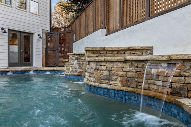 view of pool with pool water feature