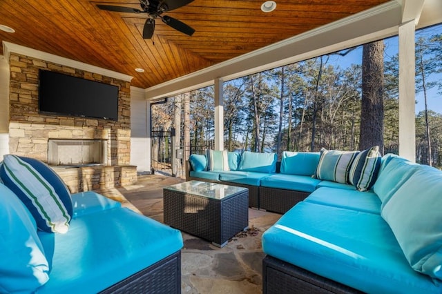 view of patio / terrace featuring an outdoor living space with a fireplace and ceiling fan