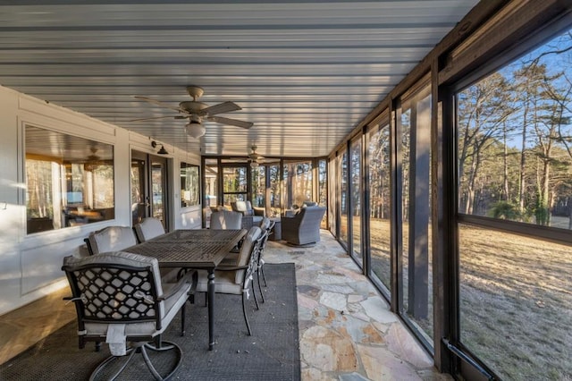 sunroom featuring ceiling fan