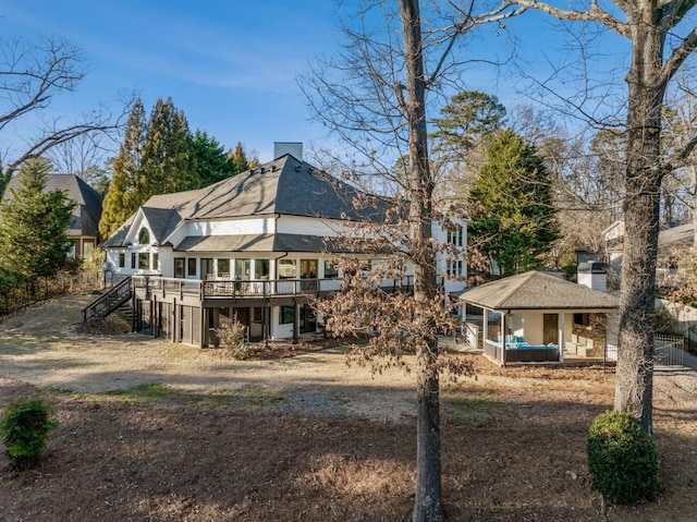 back of house with a wooden deck