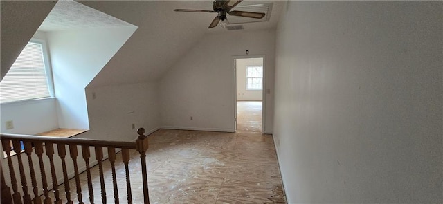 bonus room with lofted ceiling and ceiling fan