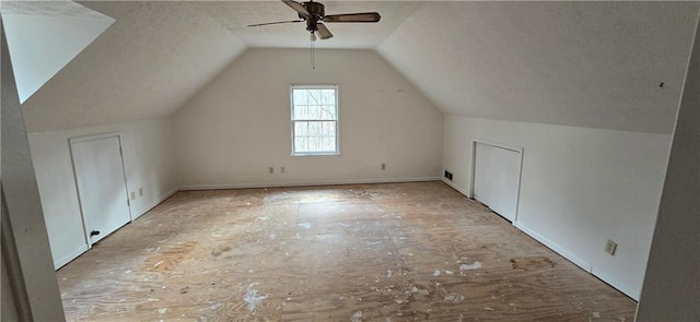 bonus room with vaulted ceiling, a textured ceiling, and a ceiling fan