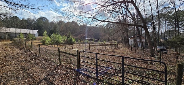 view of yard with a rural view and fence