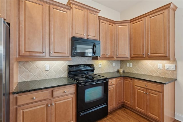 kitchen featuring backsplash, dark stone countertops, light hardwood / wood-style flooring, and black appliances