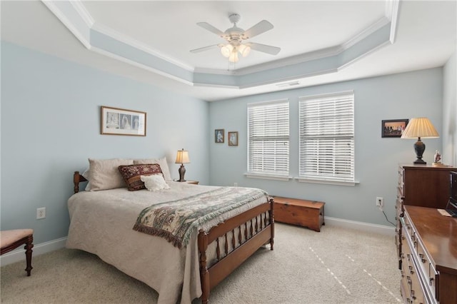 carpeted bedroom featuring a raised ceiling, ceiling fan, and crown molding