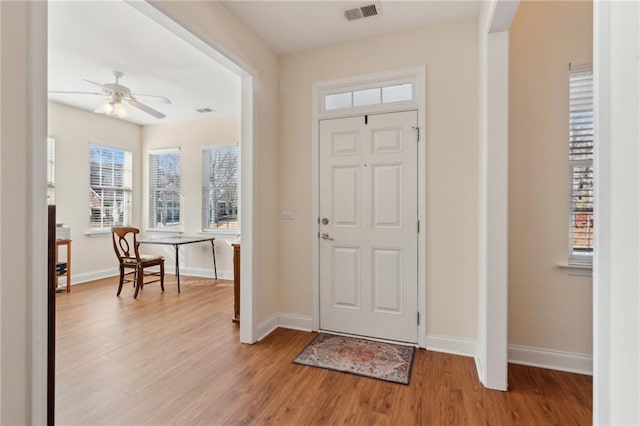 foyer with plenty of natural light, ceiling fan, and light hardwood / wood-style flooring