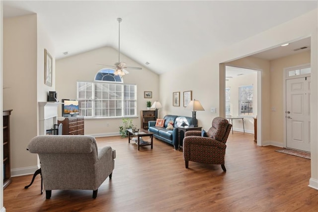 living room featuring wood-type flooring, ceiling fan, and lofted ceiling