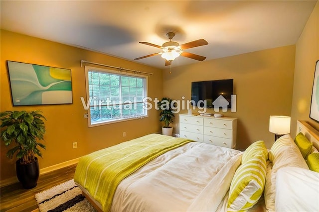 bedroom with hardwood / wood-style flooring and ceiling fan