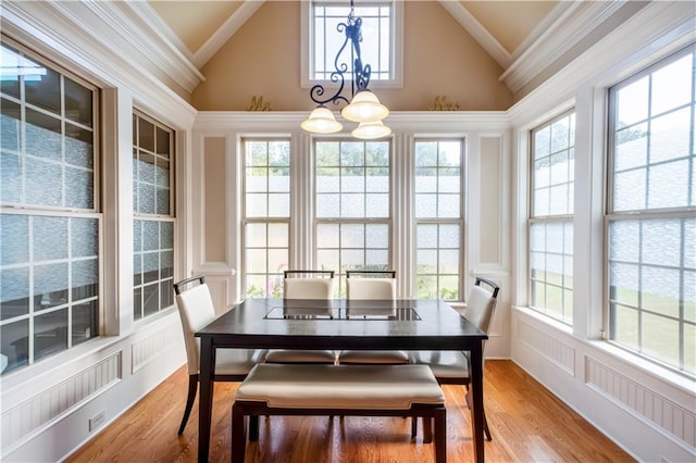 dining room featuring an inviting chandelier, high vaulted ceiling, and a wealth of natural light