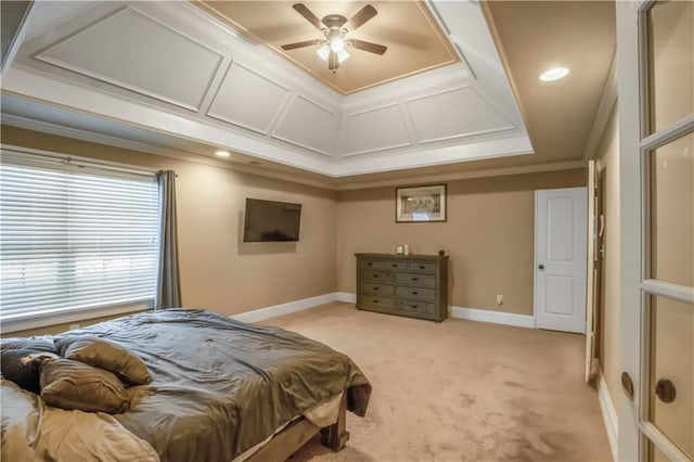 bedroom featuring ceiling fan, light colored carpet, a raised ceiling, and ornamental molding