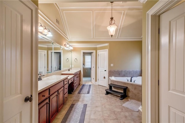 bathroom featuring ornamental molding, tile patterned floors, tiled bath, and vanity