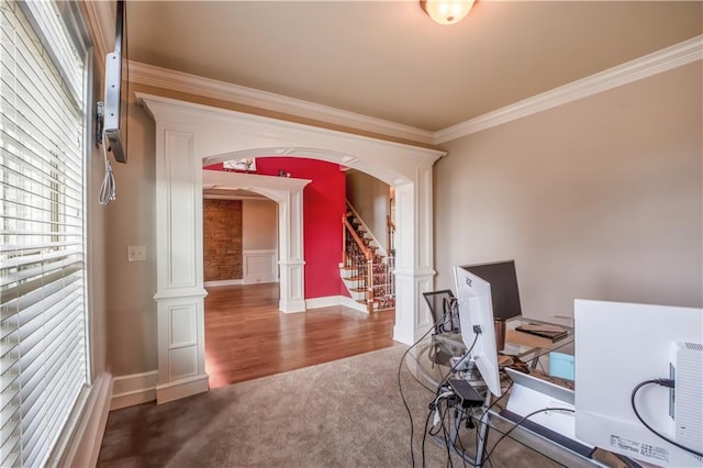 office space featuring hardwood / wood-style flooring, crown molding, and ornate columns