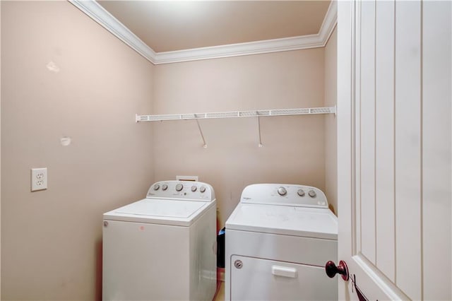 washroom with separate washer and dryer and ornamental molding