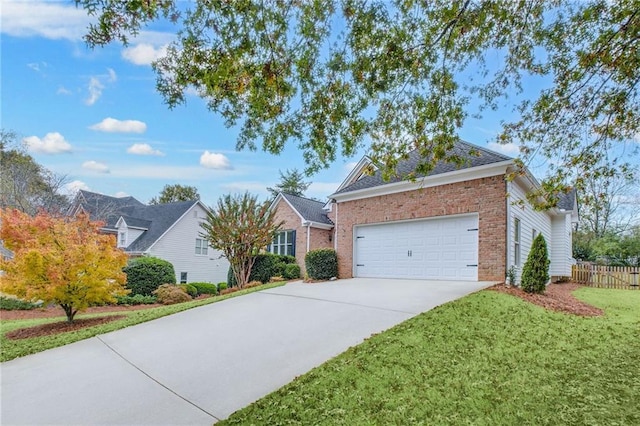 ranch-style home with brick siding, concrete driveway, an attached garage, fence, and a front yard