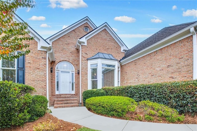 doorway to property with brick siding