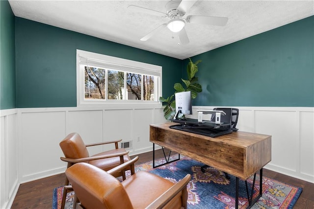 office space featuring ceiling fan, a textured ceiling, visible vents, and wood finished floors