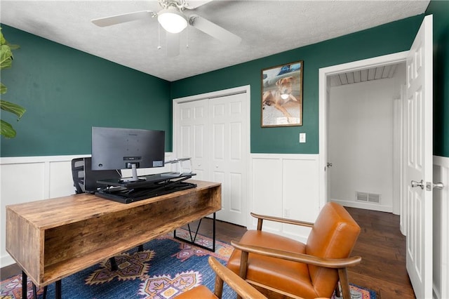 office space featuring a wainscoted wall, visible vents, and wood finished floors