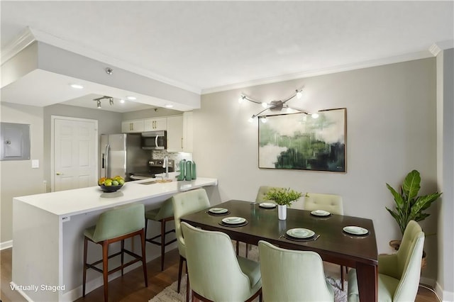 dining room featuring crown molding, dark hardwood / wood-style floors, and electric panel