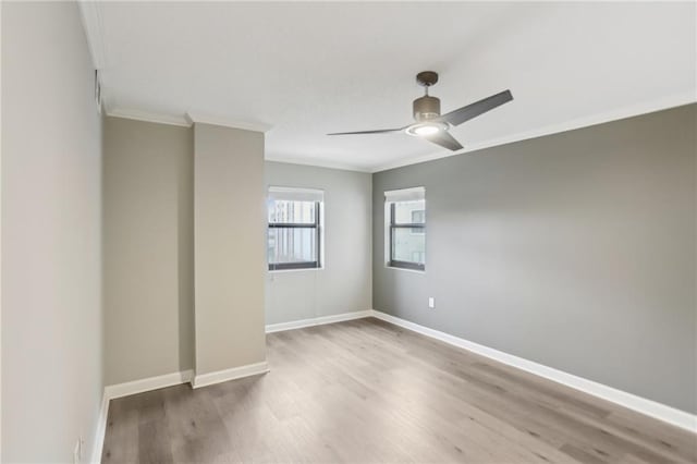 empty room featuring hardwood / wood-style flooring, crown molding, and ceiling fan