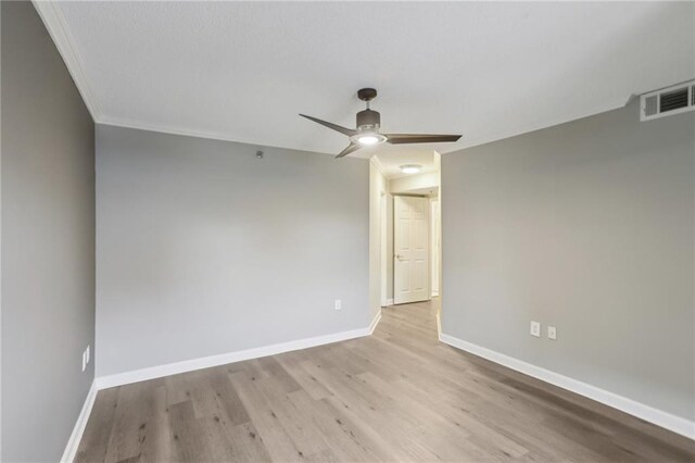 spare room featuring crown molding, ceiling fan, and light hardwood / wood-style flooring